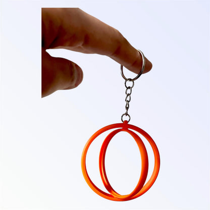Orange 2.25-inch rotating button keychain blank designed for standard flat back buttons, double-sided spinner keychain for custom button makers and DIY crafts.