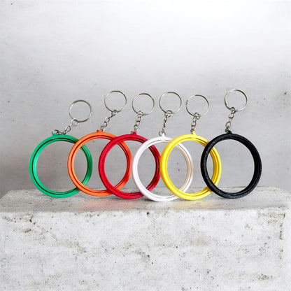2.25-inch rotating button keychain blank for standard flat back buttons, double-sided spinner keychain available in six colors for custom button designs.