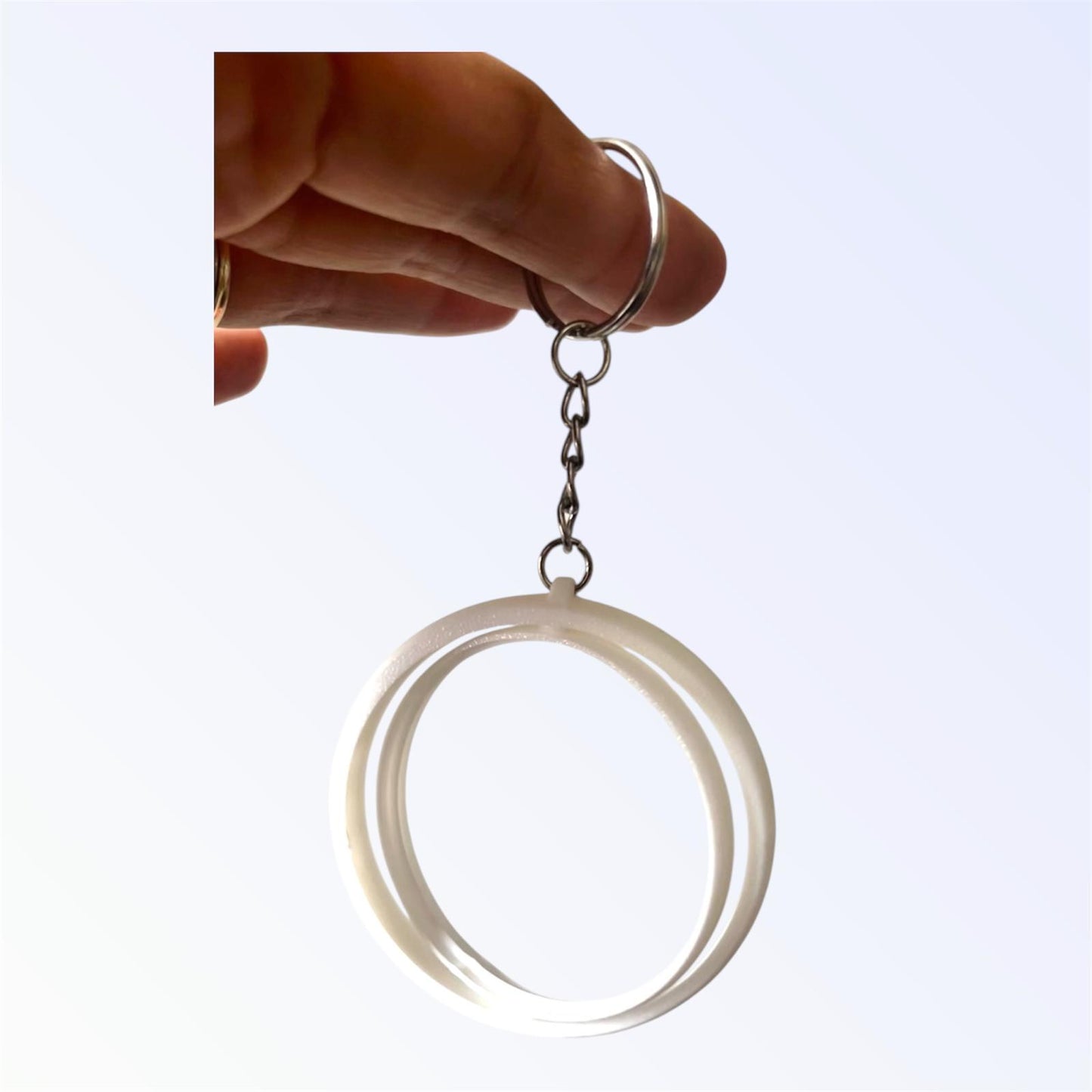 White 2.25-inch rotating button keychain blank designed for standard flat back buttons, double-sided spinner keychain for custom button makers, promotional products, and DIY crafts.