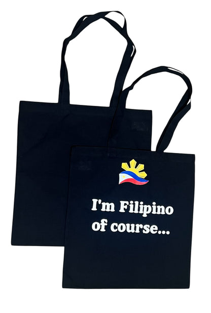 Black canvas tote bag featuring “I’m Filipino, Of Course…” design, Filipino pride reusable shopping bag for everyday use and gifts.